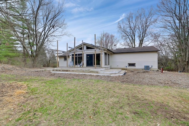 W12798 State Road 35, Prescott, WI 54021 - rear view of house with central AC, a patio area, and a yard