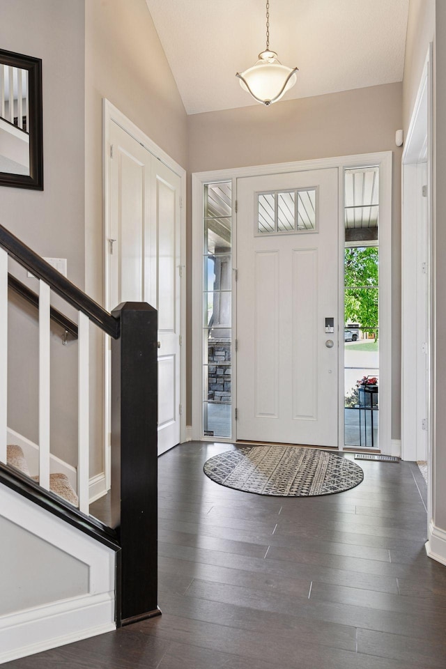 3742 Crane Island Ct, Minnetrista, MN 55331 - entryway featuring vaulted ceiling, dark wood-type flooring, baseboards, and stairs