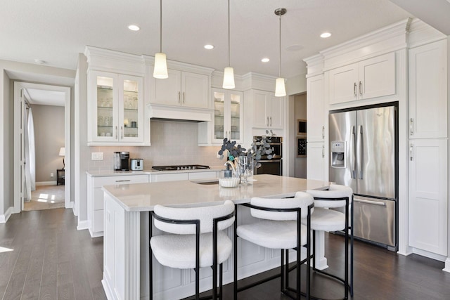 3742 Crane Island Ct, Minnetrista, MN 55331 - kitchen with stainless steel appliances, white cabinets, light countertops, dark wood-style floors, and recessed lighting