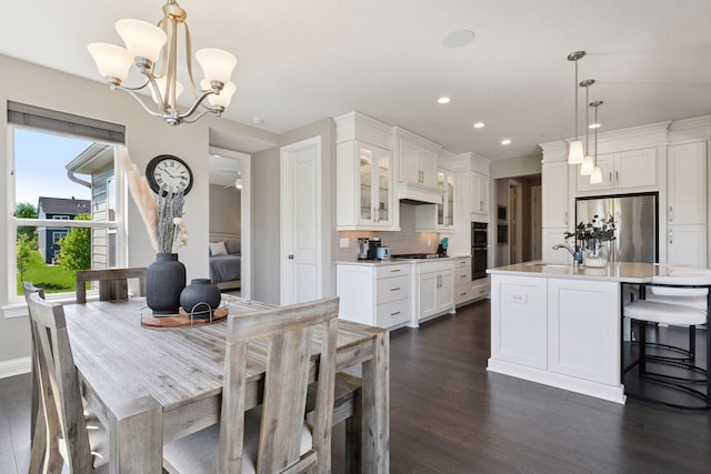 3742 Crane Island Ct, Minnetrista, MN 55331 - dining room featuring dark wood finished floors, a chandelier, recessed lighting, and baseboards