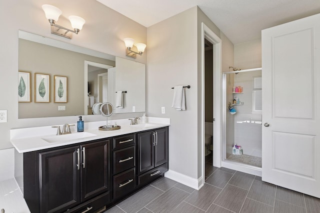 3742 Crane Island Ct, Minnetrista, MN 55331 - bathroom with double vanity, a shower stall, toilet, and baseboards