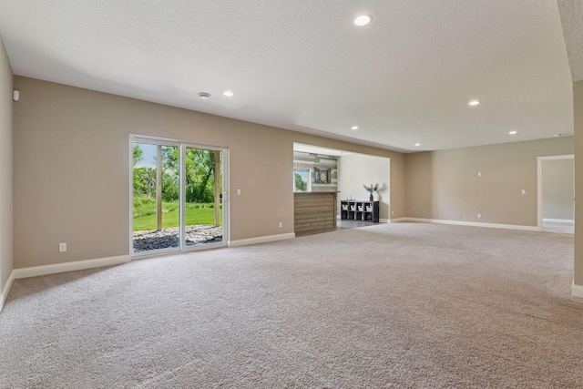 3742 Crane Island Ct, Minnetrista, MN 55331 - unfurnished living room with carpet floors, baseboards, recessed lighting, and a textured ceiling