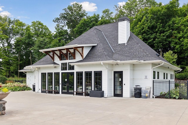 3742 Crane Island Ct, Minnetrista, MN 55331 - rear view of property with a shingled roof, a patio, and a chimney