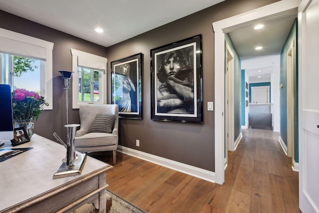 living area with hardwood / wood-style flooring, baseboards, and recessed lighting