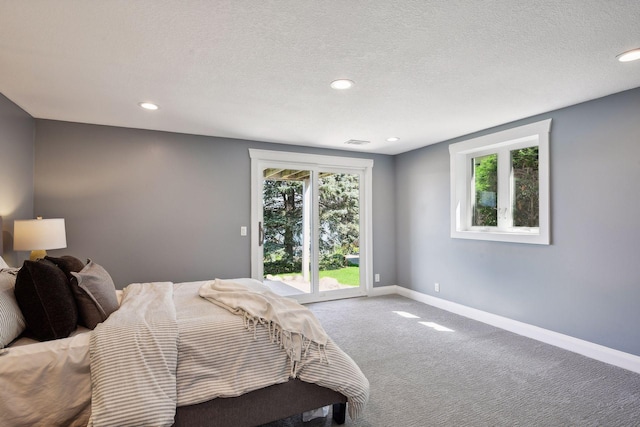 bedroom featuring access to exterior, baseboards, carpet floors, recessed lighting, and a textured ceiling