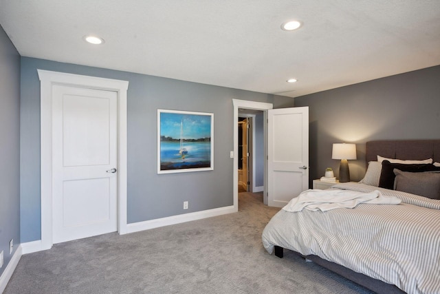carpeted bedroom featuring baseboards and recessed lighting