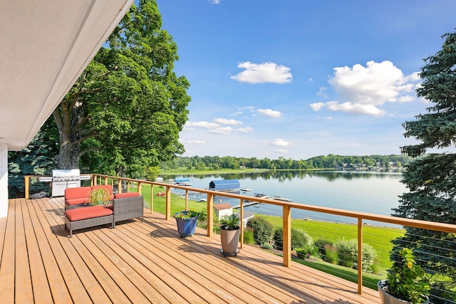 wooden deck featuring a water view and grilling area