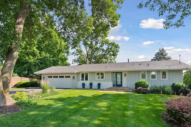 ranch-style home with an attached garage, board and batten siding, and driveway