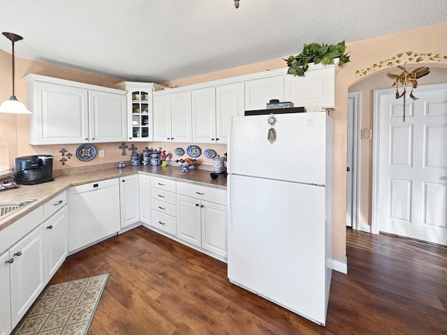 kitchen featuring white appliances, dark wood finished floors, white cabinetry, and a textured ceiling