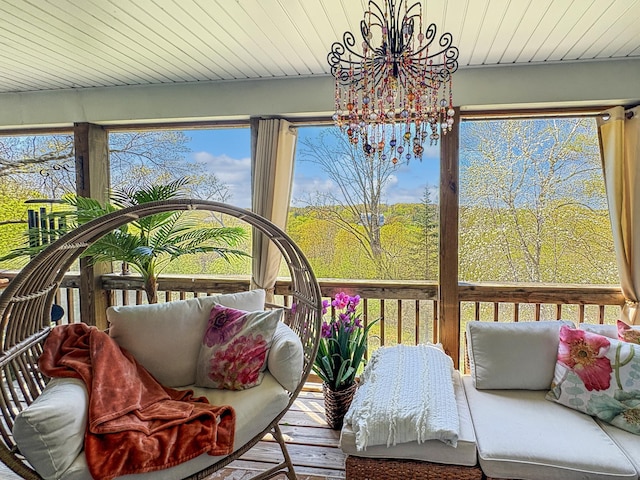 sunroom / solarium with a chandelier