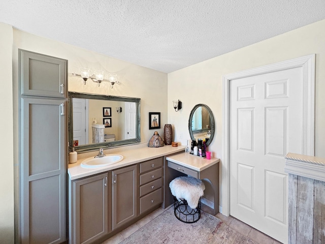 bathroom featuring tile patterned floors, a chandelier, a textured ceiling, and vanity