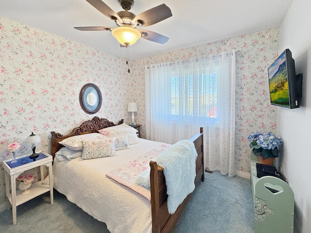 bedroom with carpet floors, wallpapered walls, and a ceiling fan