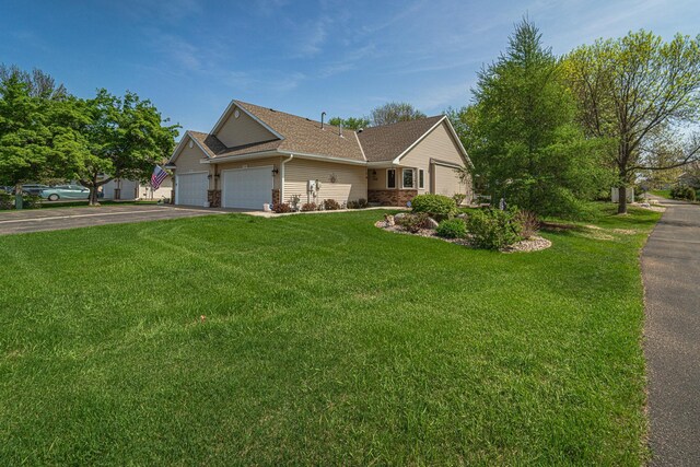 17081 Pheasant Meadow Ln SW, Prior Lake, MN 55372 - ranch-style house with an attached garage, driveway, a front lawn, and a shingled roof