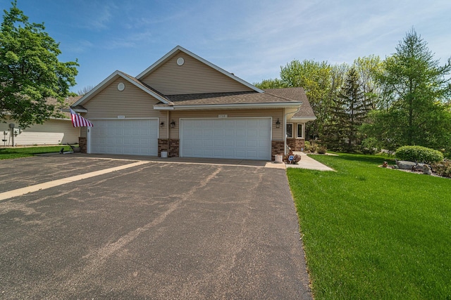 17081 Pheasant Meadow Ln SW, Prior Lake, MN 55372 - view of front facade with asphalt driveway, a front yard, an attached garage, brick siding, and roof with shingles