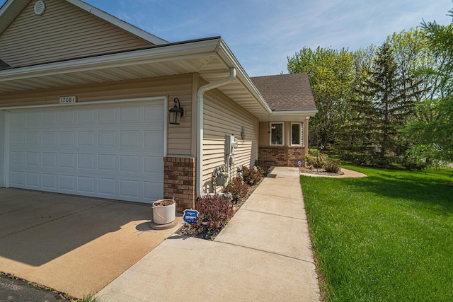 17081 Pheasant Meadow Ln SW, Prior Lake, MN 55372 - view of side of home with a lawn, brick siding, concrete driveway, a garage, and a shingled roof