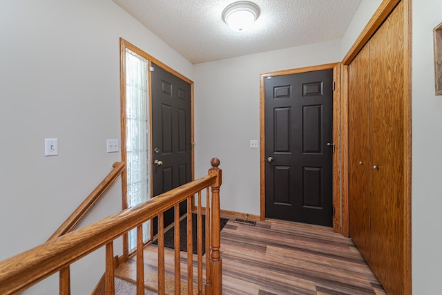 17081 Pheasant Meadow Ln SW, Prior Lake, MN 55372 - foyer featuring wood finished floors, a textured ceiling, and baseboards