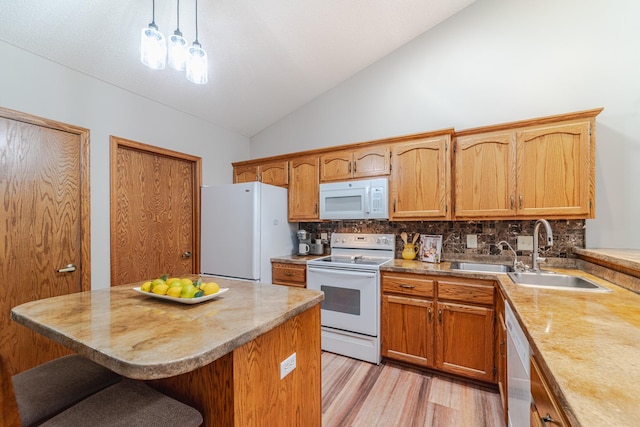 17081 Pheasant Meadow Ln SW, Prior Lake, MN 55372 - kitchen with white appliances, lofted ceiling, tasteful backsplash, light countertops, and a breakfast bar area