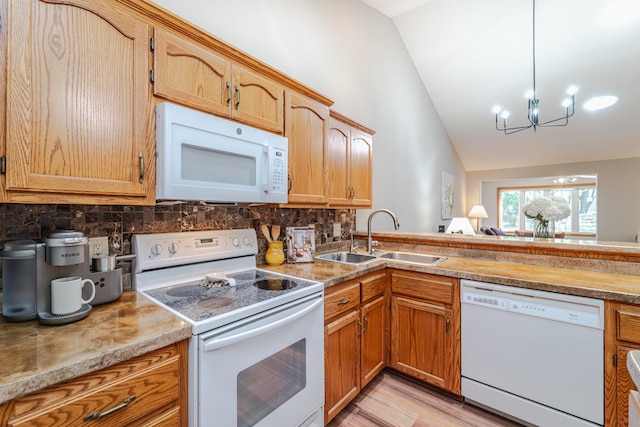 17081 Pheasant Meadow Ln SW, Prior Lake, MN 55372 - kitchen featuring white appliances, a sink, lofted ceiling, a chandelier, and tasteful backsplash