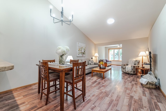 17081 Pheasant Meadow Ln SW, Prior Lake, MN 55372 - dining space with light wood-style flooring, baseboards, a chandelier, and high vaulted ceiling
