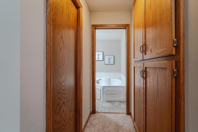 17081 Pheasant Meadow Ln SW, Prior Lake, MN 55372 - hallway with light colored carpet, a textured ceiling, and baseboards