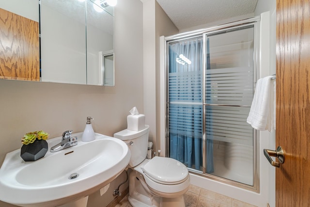 17081 Pheasant Meadow Ln SW, Prior Lake, MN 55372 - full bath featuring a sink, a shower stall, toilet, a textured ceiling, and tile patterned floors