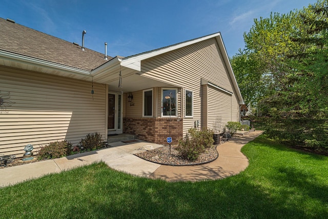 17081 Pheasant Meadow Ln SW, Prior Lake, MN 55372 - back of property with a yard, brick siding, and a shingled roof