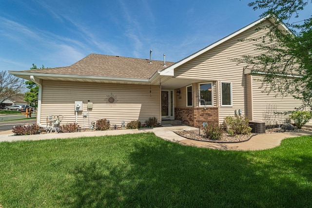 17081 Pheasant Meadow Ln SW, Prior Lake, MN 55372 - back of property with a yard, roof with shingles, brick siding, and central air condition unit