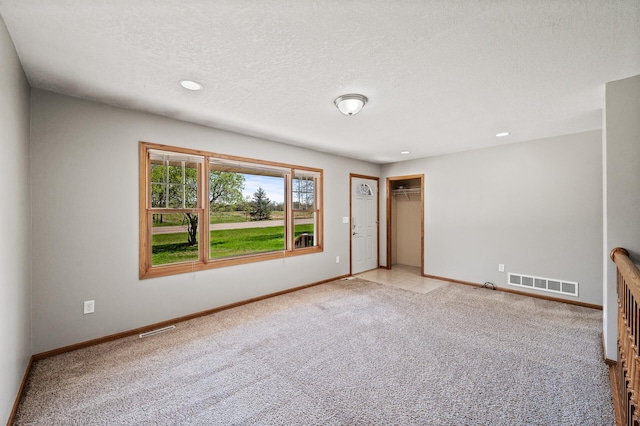 7349 Variolite Dr NW, Stanford Twp, MN 55398 - unfurnished room featuring baseboards, light colored carpet, a textured ceiling, and recessed lighting