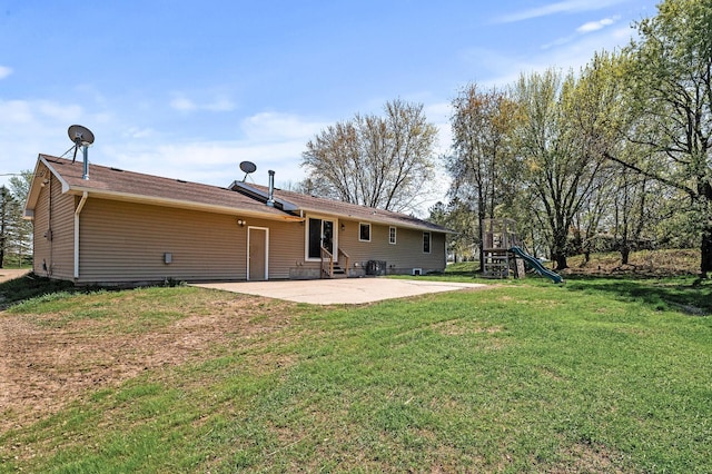 7349 Variolite Dr NW, Stanford Twp, MN 55398 - rear view of house with entry steps, a patio area, a playground, and a yard