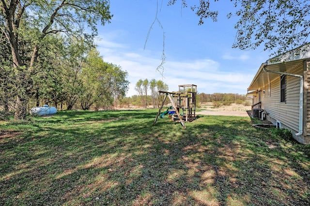 7349 Variolite Dr NW, Stanford Twp, MN 55398 - view of green lawn with a playground and central AC