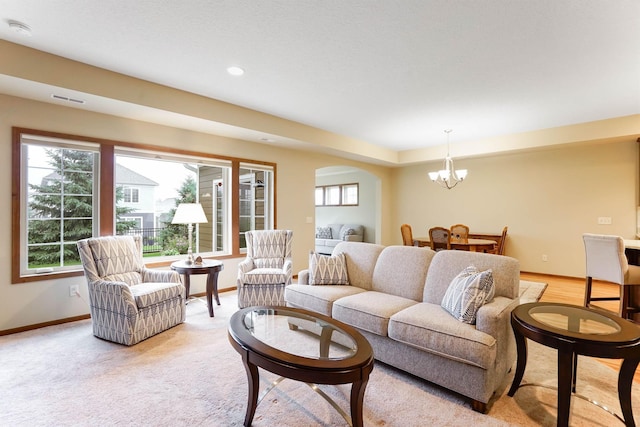 8713 9th Pl N, Lake Elmo, MN 55042 - living room with a chandelier, arched walkways, recessed lighting, and light carpet
