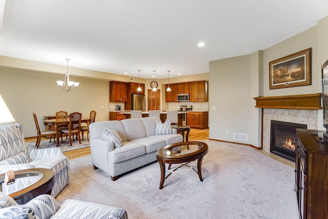 8713 9th Pl N, Lake Elmo, MN 55042 - living area featuring a chandelier, a fireplace, light colored carpet, and recessed lighting