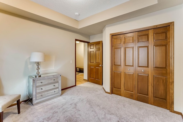 8713 9th Pl N, Lake Elmo, MN 55042 - bedroom with light colored carpet, a closet, and a textured ceiling