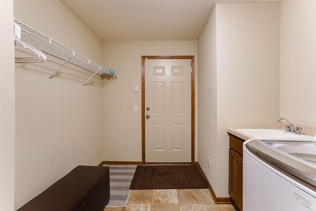 8713 9th Pl N, Lake Elmo, MN 55042 - laundry area featuring cabinet space, washer / dryer, and a textured ceiling