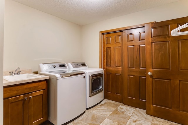 8713 9th Pl N, Lake Elmo, MN 55042 - washroom featuring washer and dryer, cabinet space, and a textured ceiling