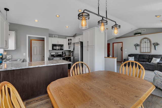223 Glenview Loop, Saint Cloud, MN 56303 - dining area featuring vaulted ceiling, wood finished floors, and recessed lighting