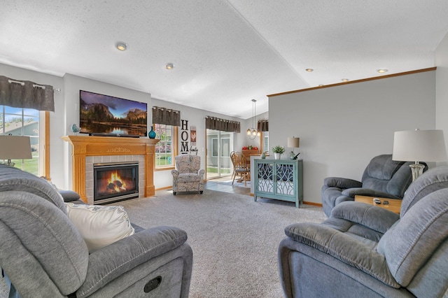 223 Glenview Loop, Saint Cloud, MN 56303 - carpeted living area with lofted ceiling, a tiled fireplace, recessed lighting, baseboards, and a textured ceiling