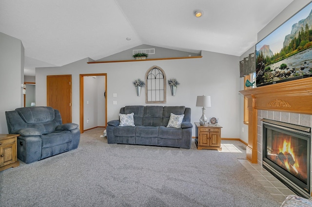 223 Glenview Loop, Saint Cloud, MN 56303 - carpeted living room featuring a tiled fireplace, vaulted ceiling, and baseboards