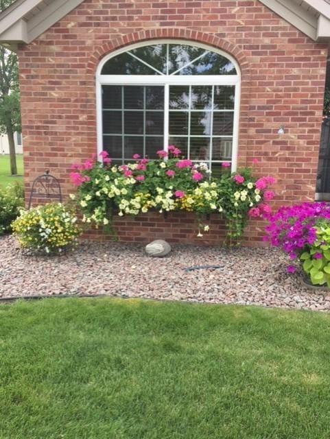 223 Glenview Loop, Saint Cloud, MN 56303 - property entrance with brick siding and a yard