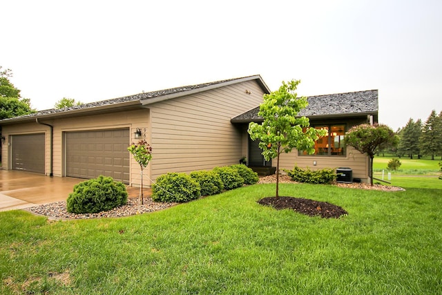 966 Rolling Greens Ln NW, Hutchinson, MN 55350 - view of home's exterior featuring a lawn, concrete driveway, central air condition unit, and a garage