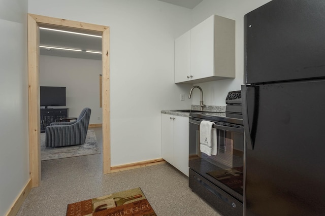 3391 Little Ida Beach Rd NW, Alexandria, MN 56308 - kitchen with black appliances, a sink, white cabinetry, baseboards, and light countertops