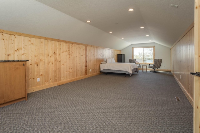 3391 Little Ida Beach Rd NW, Alexandria, MN 56308 - bedroom with vaulted ceiling, dark colored carpet, baseboards, wood walls, and recessed lighting