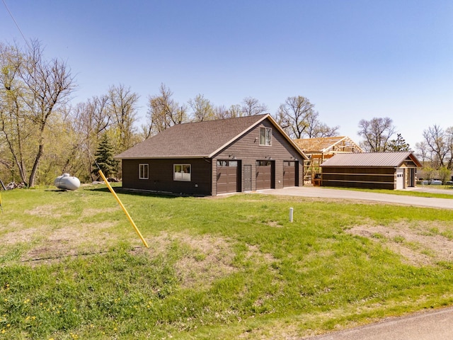 3391 Little Ida Beach Rd NW, Alexandria, MN 56308 - view of front of property featuring a detached garage, an outdoor structure, and a front yard