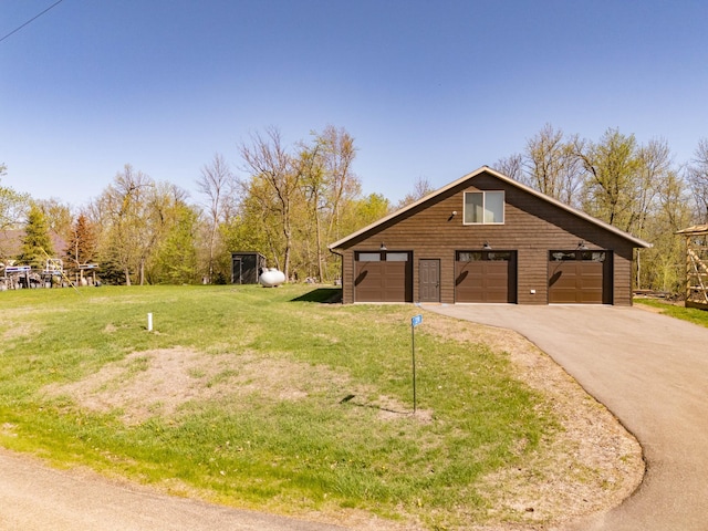3391 Little Ida Beach Rd NW, Alexandria, MN 56308 - view of home's exterior with a lawn, a detached garage, and asphalt driveway