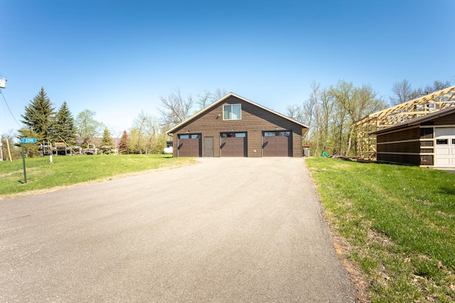 3391 Little Ida Beach Rd NW, Alexandria, MN 56308 - view of side of property with a yard, a garage, and an outbuilding