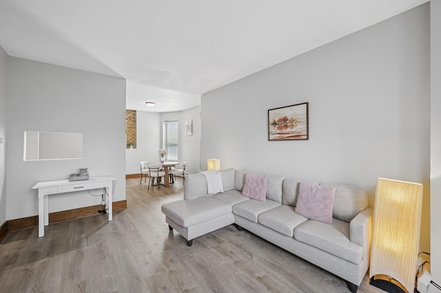 1811 Elliot Ave Unit 2, Minneapolis, MN 55404 - living room featuring wood finished floors, baseboard heating, and baseboards