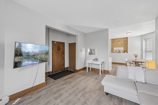 1811 Elliot Ave Unit 2, Minneapolis, MN 55404 - living area featuring a baseboard heating unit, light wood finished floors, and baseboards