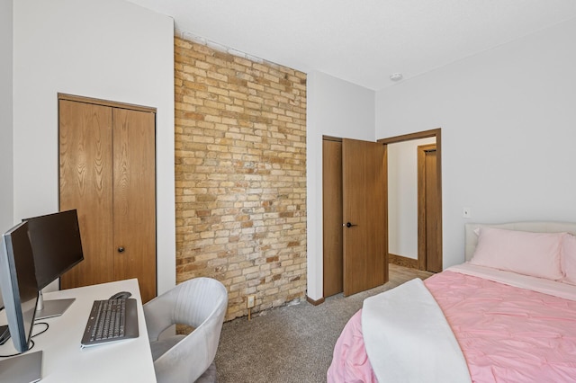 1811 Elliot Ave Unit 2, Minneapolis, MN 55404 - carpeted bedroom featuring brick wall and multiple closets