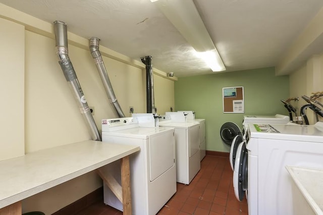 1811 Elliot Ave Unit 2, Minneapolis, MN 55404 - communal laundry room featuring washing machine and dryer, dark tile patterned flooring, and baseboards