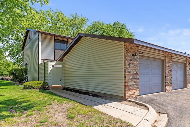 13501 Heather Hills Dr, Burnsville, MN 55337 - view of home's exterior featuring driveway and an attached garage